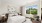 bedroom with large window and white bedding